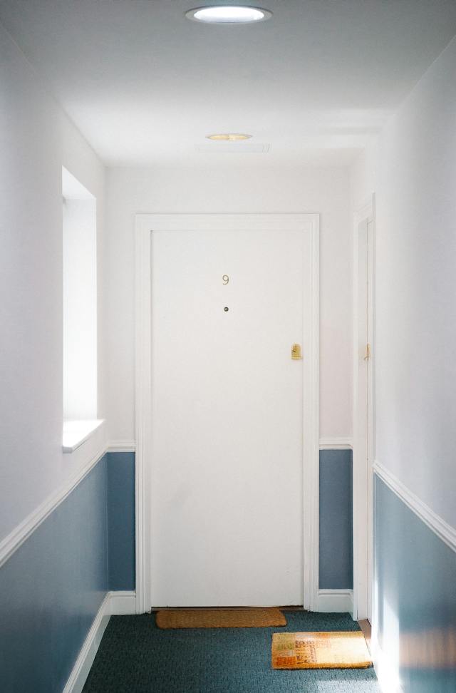 image of a hallway with a door at the end