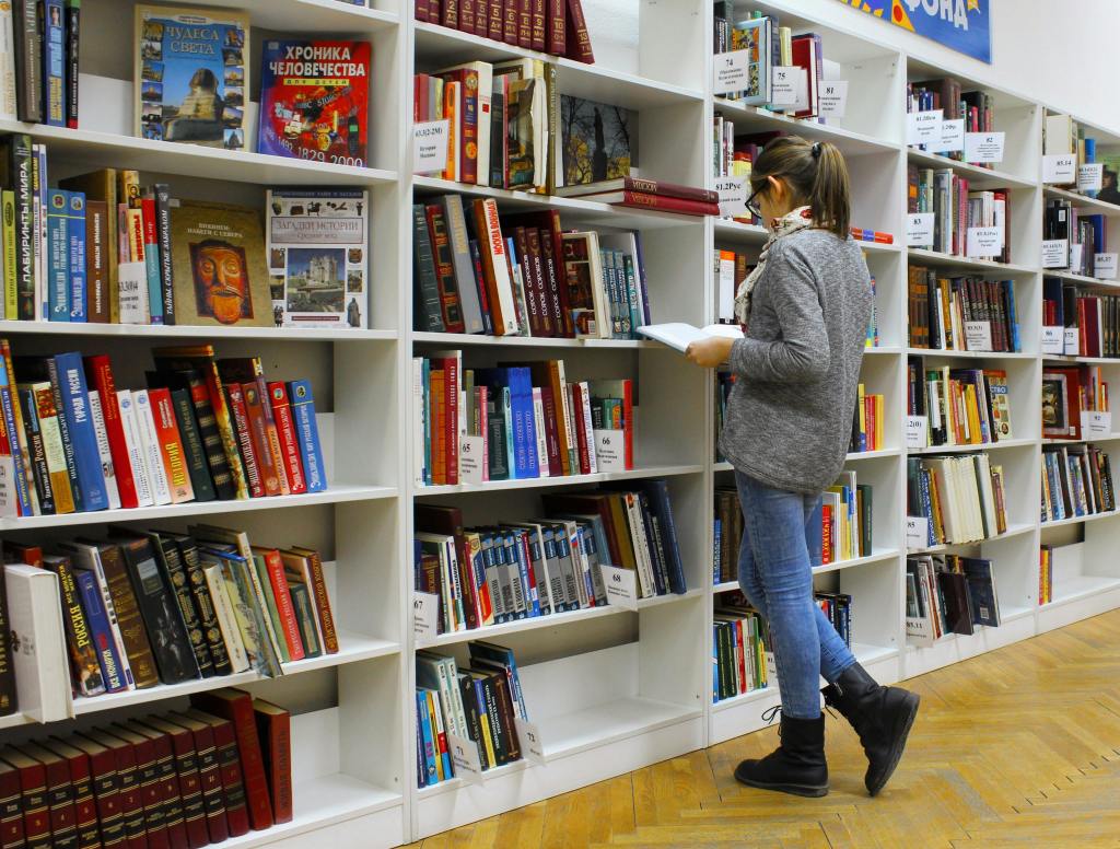 A keen reader browsing through a bookshop.